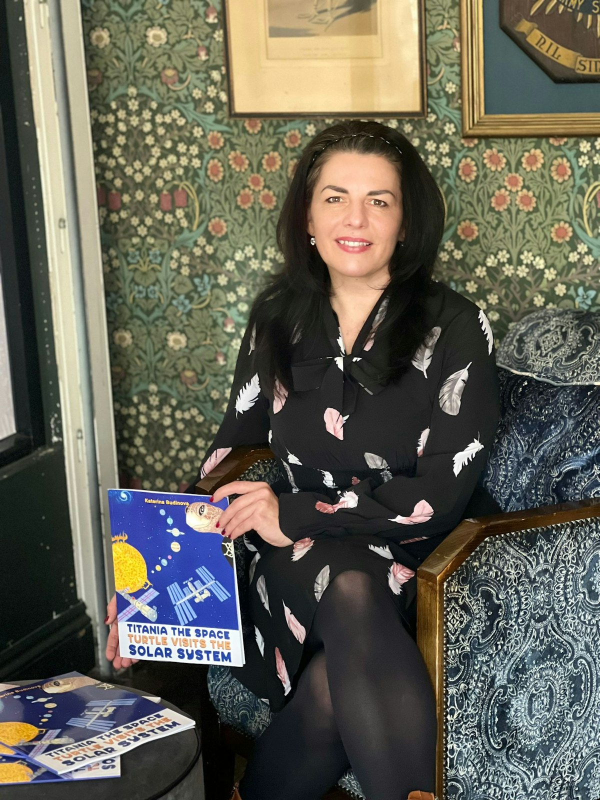 Katerina Budinova holding a copy of her book